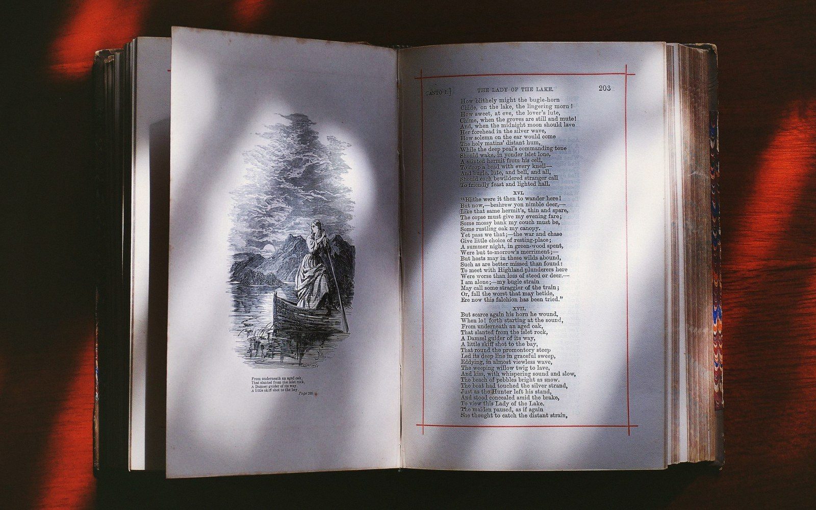 Open antique book showing an illustrated engraving of a woman in a boat facing printed verse